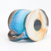Flat bottom mug sprayed with "positive blue"