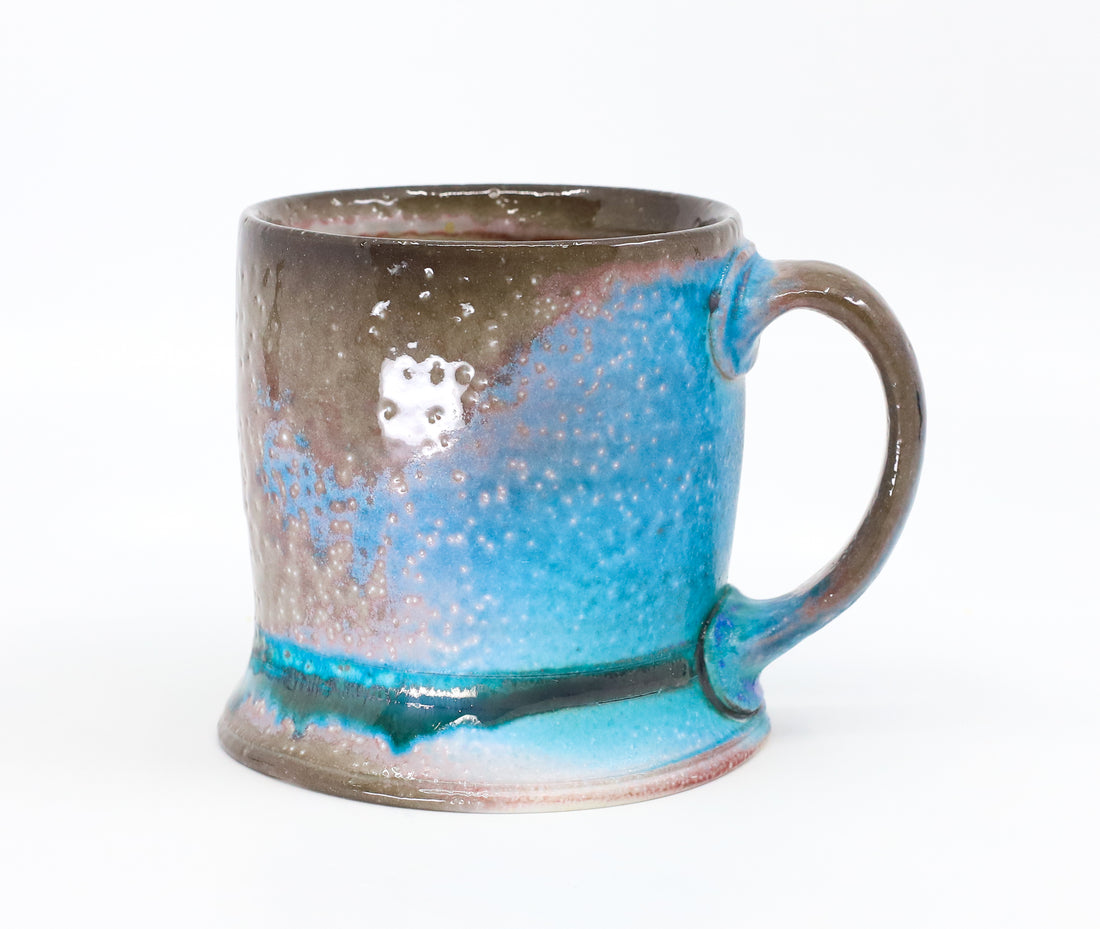 Flat bottom mug sprayed with "positive blue"
