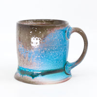 Flat bottom mug sprayed with "positive blue"