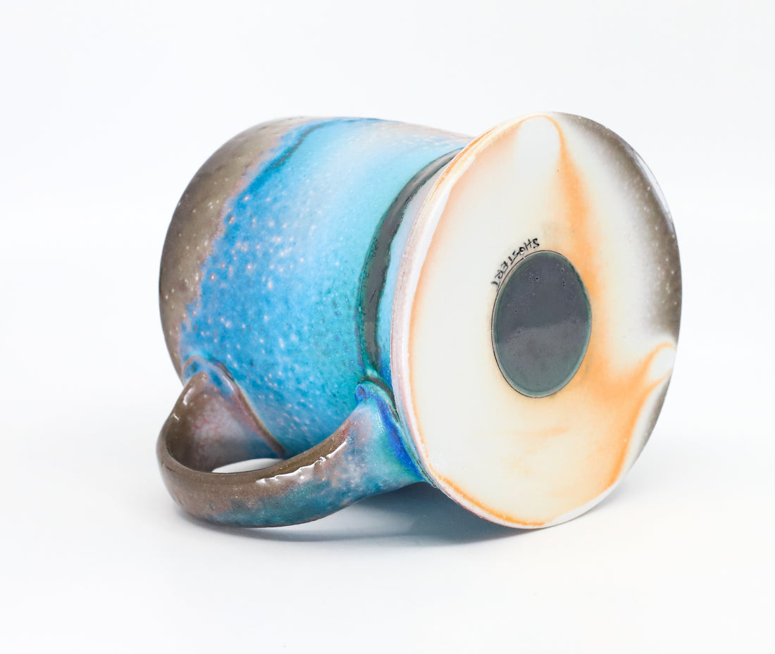 Flat bottom mug sprayed with "positive blue"